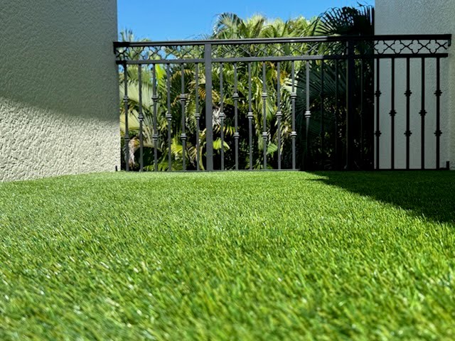 Close-up view of Evergreen Tech artificial grass showing realistic green turf texture and durable fibers.