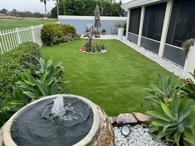 Residential backyard designed with Evergreen Tech artificial grass, featuring a low-maintenance green lawn for outdoor living.