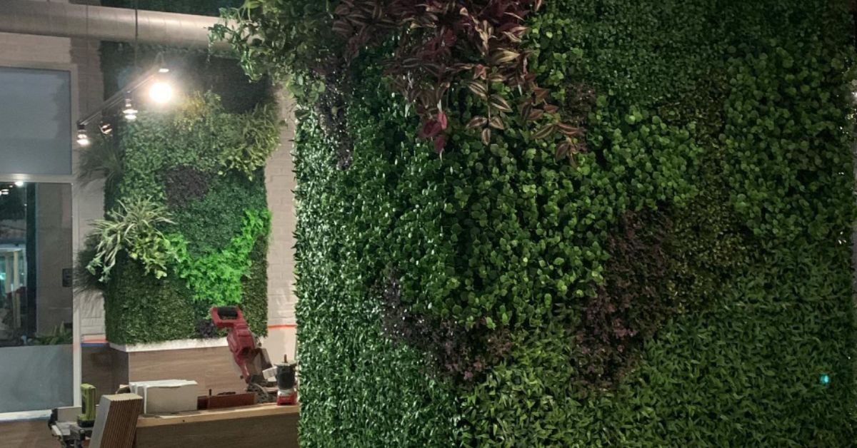A modern artificial green wall installed by Evergreen Tech Landscaping, adding a lush and vibrant touch to an outdoor space.